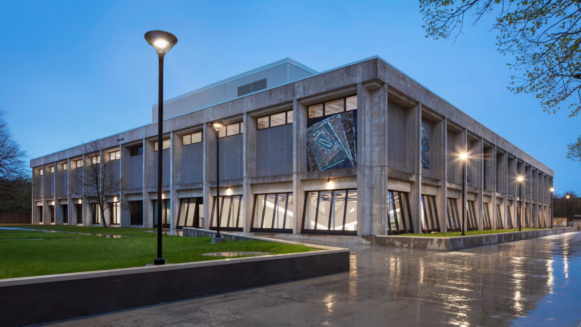 tyler hall, a box like building with large windows at dusk