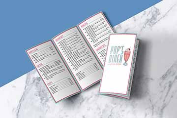 50s themed diner menu with pastel pink and blue color scheme, menu is tri-fold and lists food in various categories