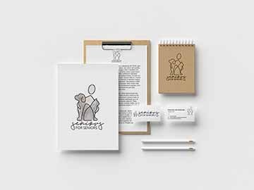 mockup of a variety of print materials that feature the seniors for seniors logo which includes a minimalistic line drawing of a person with their arms around a cat and dog