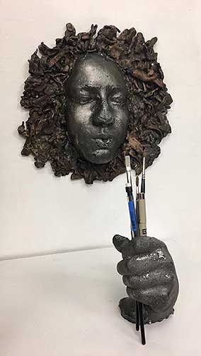 Portrait made out of iron depicting the artist of the piece.