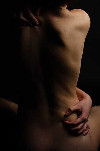 Troubled is shot similarly to Impure as it is a back portrait of a woman except she is sitting in this photograph. She has her arms wrapped almost like giving herself a hug, except that her hands are gripping her back with such force.
