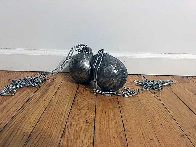 Two ‘balls and chains’ that were part of a performance art. The balls are made out of iron and sanded down to create a battered feel to them.