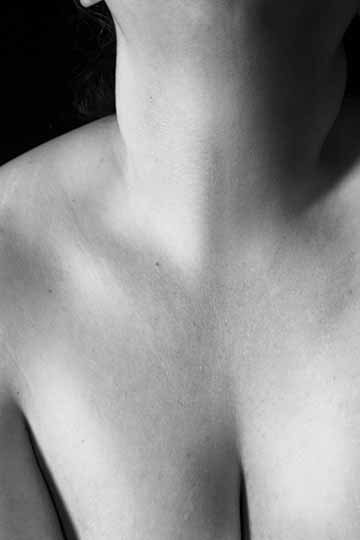 A black and white photograph of a chest and neck with a very high contrast
