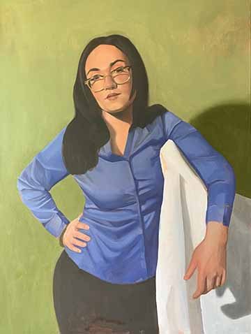 This is a portrait of a black haired white woman with a blue button down shirt and black pants. She has her hand on her hip and the other arm draped over a shoulder height object that is covered in a white sheet. Her expression is neutral and the background is a bright green. 