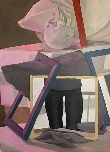 This is a still life painting of items on a table. There is a mirror reflecting back the legs of the painter. Behind the mirror there is a grey pillow and different colored frames. Then behind those, there is a box that has a model skull upside down and faced away and white pillow. 