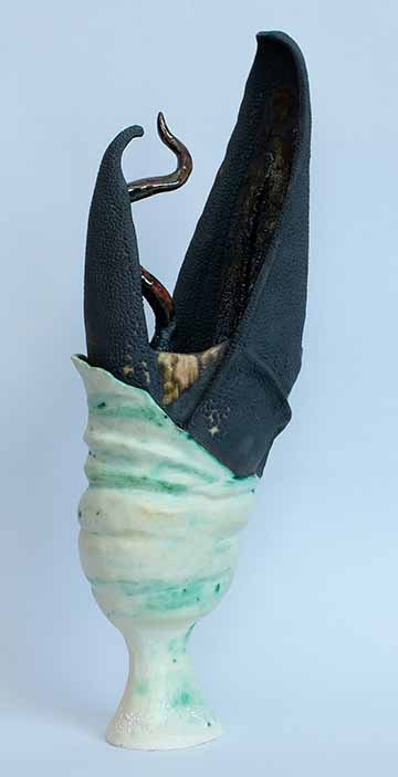 The top half is a black beak form with a wriggling tongue coming out vertically. The bottom is white with green shading and shaped similarly to a hefty goblet. The area where the forms meet contains wrinkles and folds as if grown organically. The piece is vertically oriented and wider at the top (the open beak) than the bottom.
