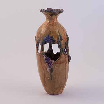 Image a: A bottle shaped vessel with openings showing the inside about halfway up the body. It is brownish-orange with blue and purple details. The organic shapes of the openings are framed by drips and torn skin forms. The top of the bottle cinches at the neck then reopens with an unfinished brim. Red drops are scattered over the piece.