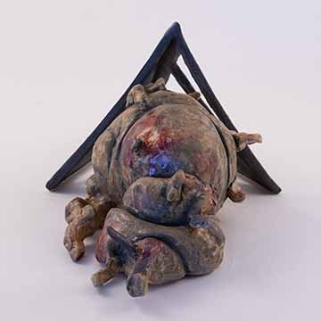 Image b: Another view of the previous piece. The cage form behind the blobby form is mostly obscured. There is dark shading in the folds of the blobby form. Shiny, red splotches surround the back bits coming out of the blob.