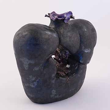 ​​​​​​​Image b: A three quarter view of the previous vase. The crystals are mostly obscured by the angle of the vase.