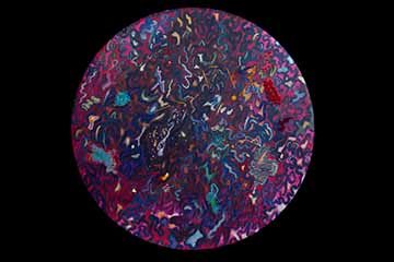 Around canvas covered with squiggly blue lines interspersed with red, yellow, white, and green areas. The dominant colors are red and blue. The painted surface is adorned with embroidery including pink, blue, and red dots, orange, and blue lines, white stripes and loops, a blue star, a red ruffle, and three light blue fabric bunches. 