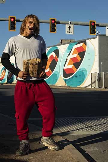 “Carter” is also a piece as well as an individual used in a series titled “Faces Around Town”. Similar to many of the other photos in the series, Carter is photographed at his preferred intersection to work at. The photo was taken using natural light and contains very vibrant colors throughout. During the time of the shoot, Carter was dancing as he usually does while he works, and this photo expresses his happy, go-lucky personality.