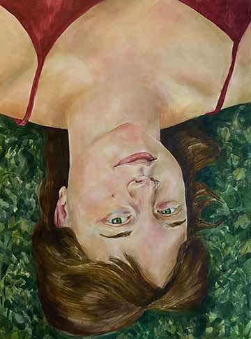 This watercolor is a self portrait. It shows a face and shoulders from above, with the figure laying down in the grass. It is presented with the face upside down to the viewer. 